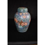 A LARGE CHINESE CLOISONNE LIDDED JAR of baluster form, decorated with blossoming trees on a blue
