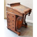 19TH CENTURY MAHOGANY DAVENPORT with a leather insert, the hinged top opening to reveal two faux