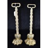 A PAIR OF BRASS LION PAW DOORSTOPS 38cm high Condition Report : one with a cast iron loaded base,