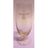 MILITARIA - A GERMAN THIRD REICH DRINKING GLASS with an etched eagle motif, 14cm high. Provenance: