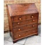 19TH CENTURY OAK BUREAU the fall front opening to reveal a central compartment set back with two