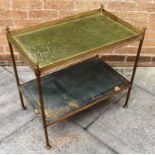 A GILT METAL FRAMED TWO TIER OCCASIONAL TABLE with gilt tooled green leather tops, 65cm wide 41cm