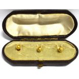 A BOXED SET OF THREE 9CT GOLD GENTS DRESS STUDS the small stud is hallmarked 1947, a total gold