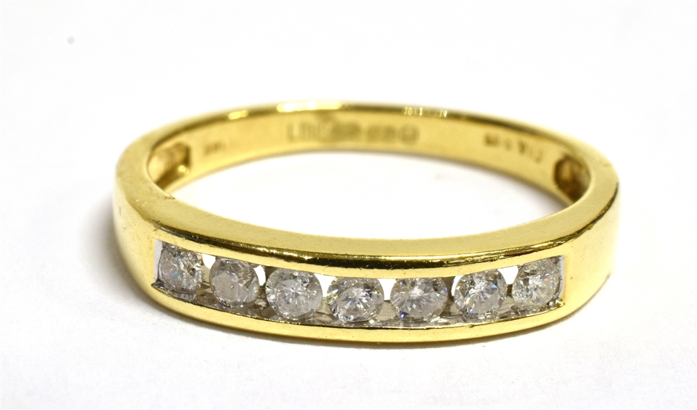 A DIAMOND HALF ETERNITY 18CT GOLD RING The channel set front containing 7 small set round