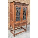 20th CENTURY DISPLAY CABINET, with astragal glazed lead doors, and raised on barley twist supports