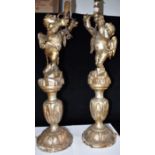 A LARGE PAIR OF CARVED AND GILDED FIGURAL LAMP BASES modelled as cherubs, approx 89cm high overall