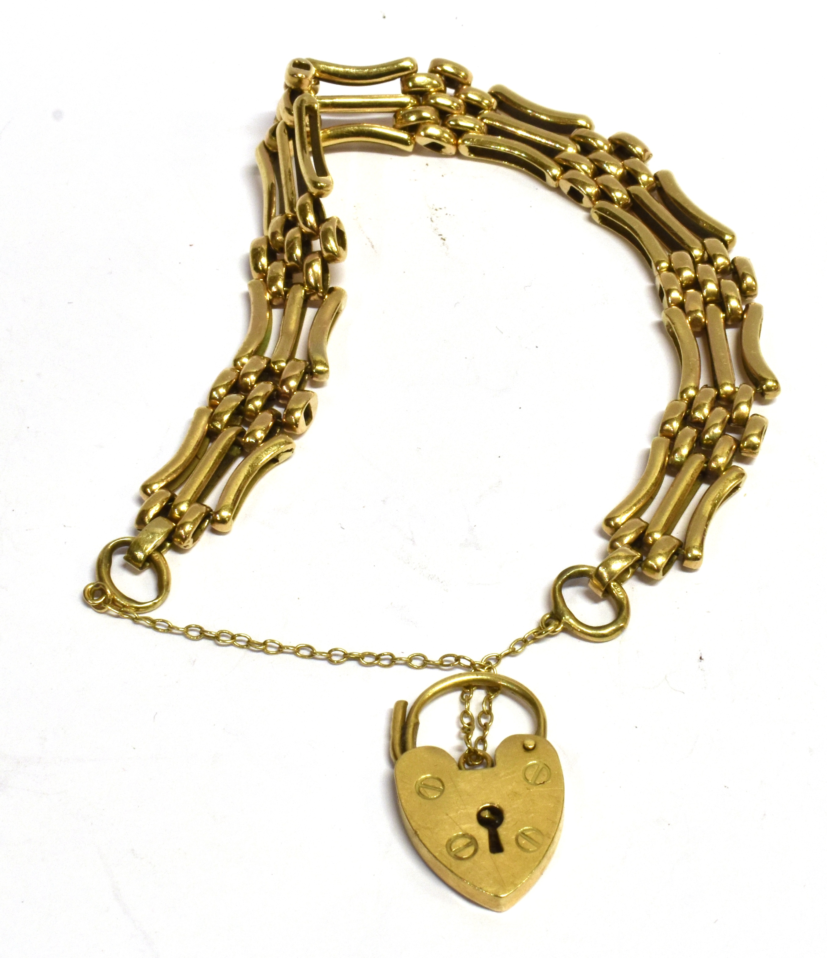 A 9CT GOLD GATE BRACELET with padlock fastener, the three bar gate links with seven small belcher