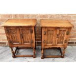 A PAIR OF OAK BEDSIDE CABINETS, the doors with carved decoration, 51cm wide 33cm deep 69cm high
