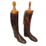 A PAIR OF GENTLEMAN'S BROWN LEATHER HUNTING BOOTS complete with trees