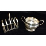 A HARRODS SILVER TOAST RACK together with a silver sugar bowl, the four slice toast rack