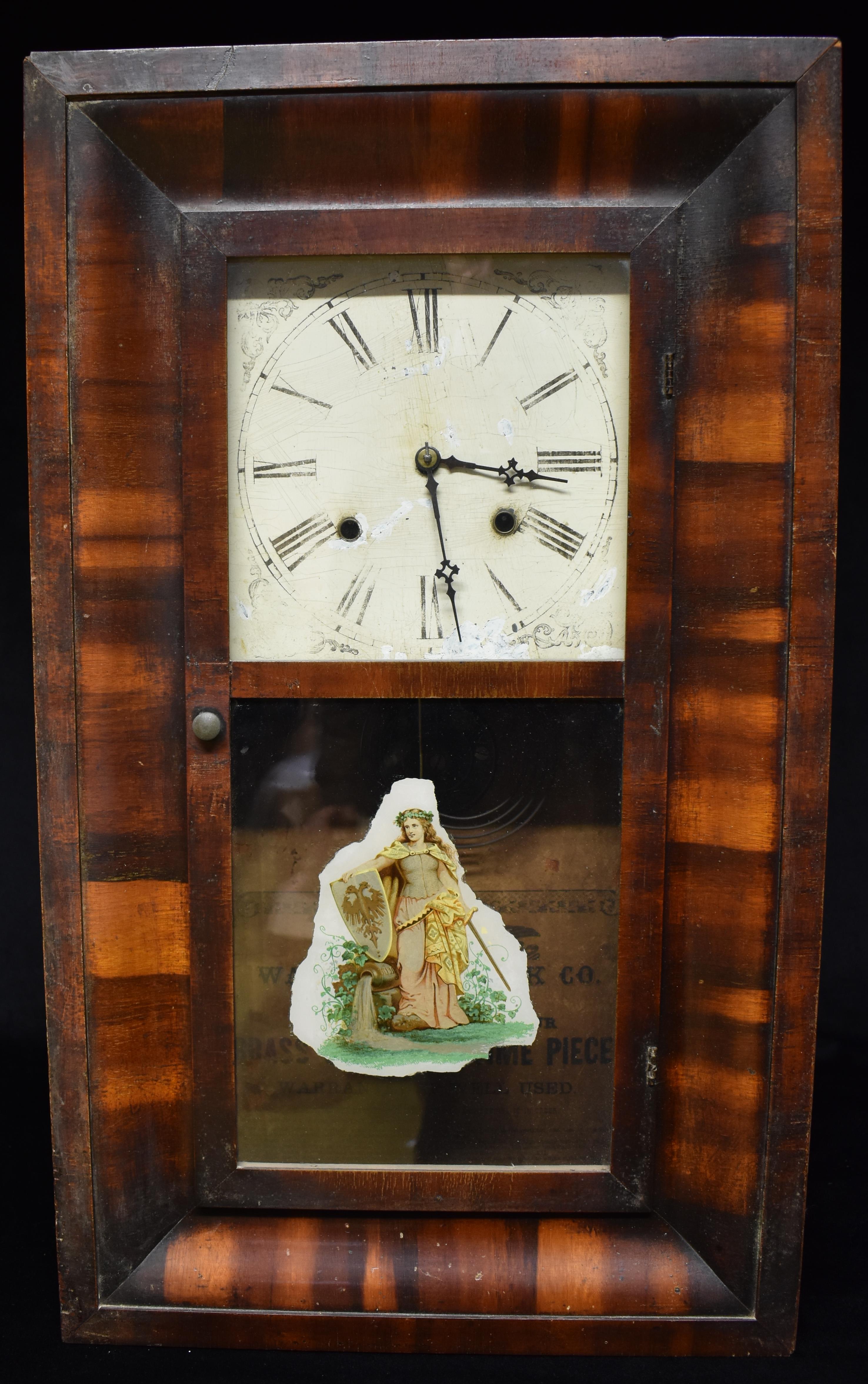 AN AMERICAN WALL CLOCK in rosewood case, paper trade label for the Waterbury Clock Co.,