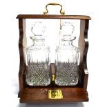 A CONTEMPORARY METAL BOUND TANTALUS with pair of Stuart crystal decanters and stoppers, the frame