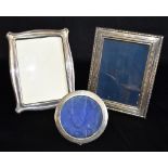 THREE SILVER PHOTO FRAMES Comprising a rectangular with blue felt backing and easel stand 22cm x