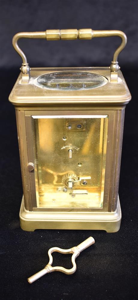 A BRASS CARRIAGE CLOCK the enamel dial with Roman numerals, inscribed 'T R RUSSELL P*RIS', 15cm high - Image 2 of 2