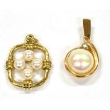 TWO SMALL CULTURED PEARL SET GOLD PENDANTS comprising a single button shaped pearl set with very