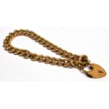 A 9CT GOLD CURB LINK BRACELET with padlock fastener solid twisted link 20cms long weighing approx.