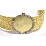 A LADIES PIAGET 18CT GOLD BRACELET WATCH WITH DIAMOND BEZEL The oval champagne dial with minute