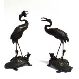 A PAIR OF JAPANESE MEIJI PERIOD SPELTER FIGURES modelled as cranes standing atop minogame turtles