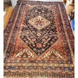 A RED GROUND RUG the main field with ivory central medallion, stylised animals within multiple