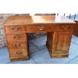 STAINED PINE DESK WITH MOULDED RIM, the top with a central frieze drawer flanked by two