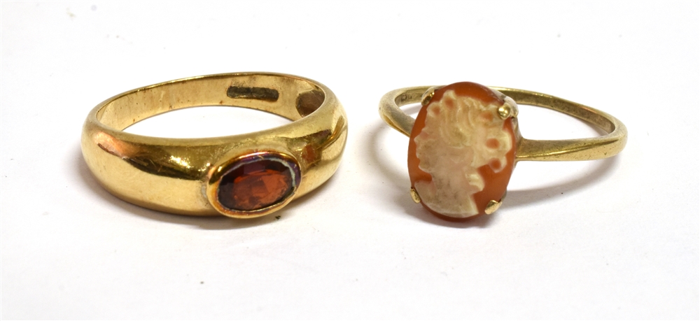 TWO 9 CARAT GOLD DRESS RINGS comprising a garnet set band ring, size N, and small cameo ring size M,