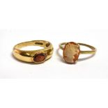 TWO 9 CARAT GOLD DRESS RINGS comprising a garnet set band ring, size N, and small cameo ring size M,