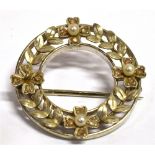 AN EDWARDIAN SMALL ROUND OPENWORK 18CT WHITE GOLD AND PLATINUM BROOCH the front decorated with