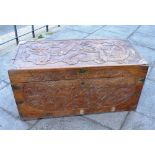 A CAMPHOR WOOD TRUNK, with moulded dragon decoration and carrying handles to each side, 49cm x 103cm