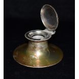 A SILVER CAPSTAN SHAPED INKSTAND by Elkington & Co the large stand of circular shape plain with