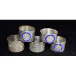 THREE SILVER NAPKIN RINGS each with blue enamelled Bowling Club disc, weighing a total of approx. 72