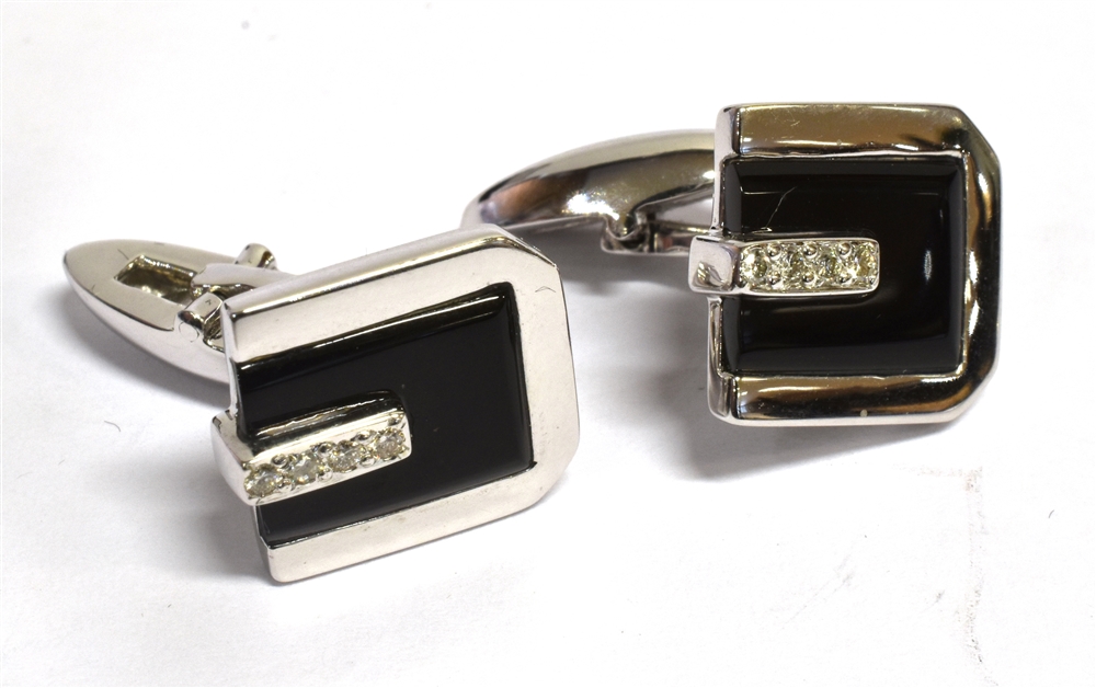 A PAIR OF 18CT WHITE GOLD DIAMOND AND ONYX SET CUFFLINKS each comprising four diamonds to onyx