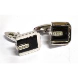A PAIR OF 18CT WHITE GOLD DIAMOND AND ONYX SET CUFFLINKS each comprising four diamonds to onyx