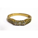 A DIAMOND THREE STONE 9CT GOLD RING with diamond set shoulders, stamped, total diamond weight of 0.