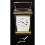 A BRASS CARRIAGE CLOCK the enamel dial with Roman numerals, inscribed 'T R RUSSELL P*RIS', 15cm