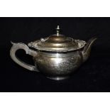 A LARGE SILVER PRESENTATION TEAPOT The melon shaped teapot with gadroon border, hardwood handle