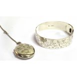 A SILVER HINGED BANGLE by Charles Horner of traditional belt form, scroll engraved, hinged with hook