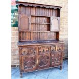 2OTH CENTURY OAK DRESSER, the upper section having a panelled back with a long open shelf, above two