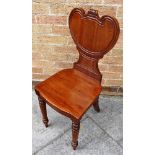 GEORGE III MAHOGANY HALL CHAIR, with a heart shaped back and raised on circular tapering legs to the