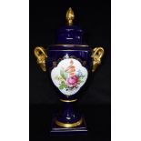 A LARGE CONTINENTAL TWIN HANDLED LIDDED VASE the reserves decorated with floral spray on a Royal