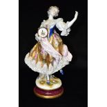 A LARGE NAPLES (CAPODIMONTE) FIGURE OF A LADY modelled dancing and holding a tambourine, with gilt