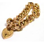 AN EDWARDIAN 9CT GOLD CURB LINK BRACELET with padlock fastener, the alternating plain and textured