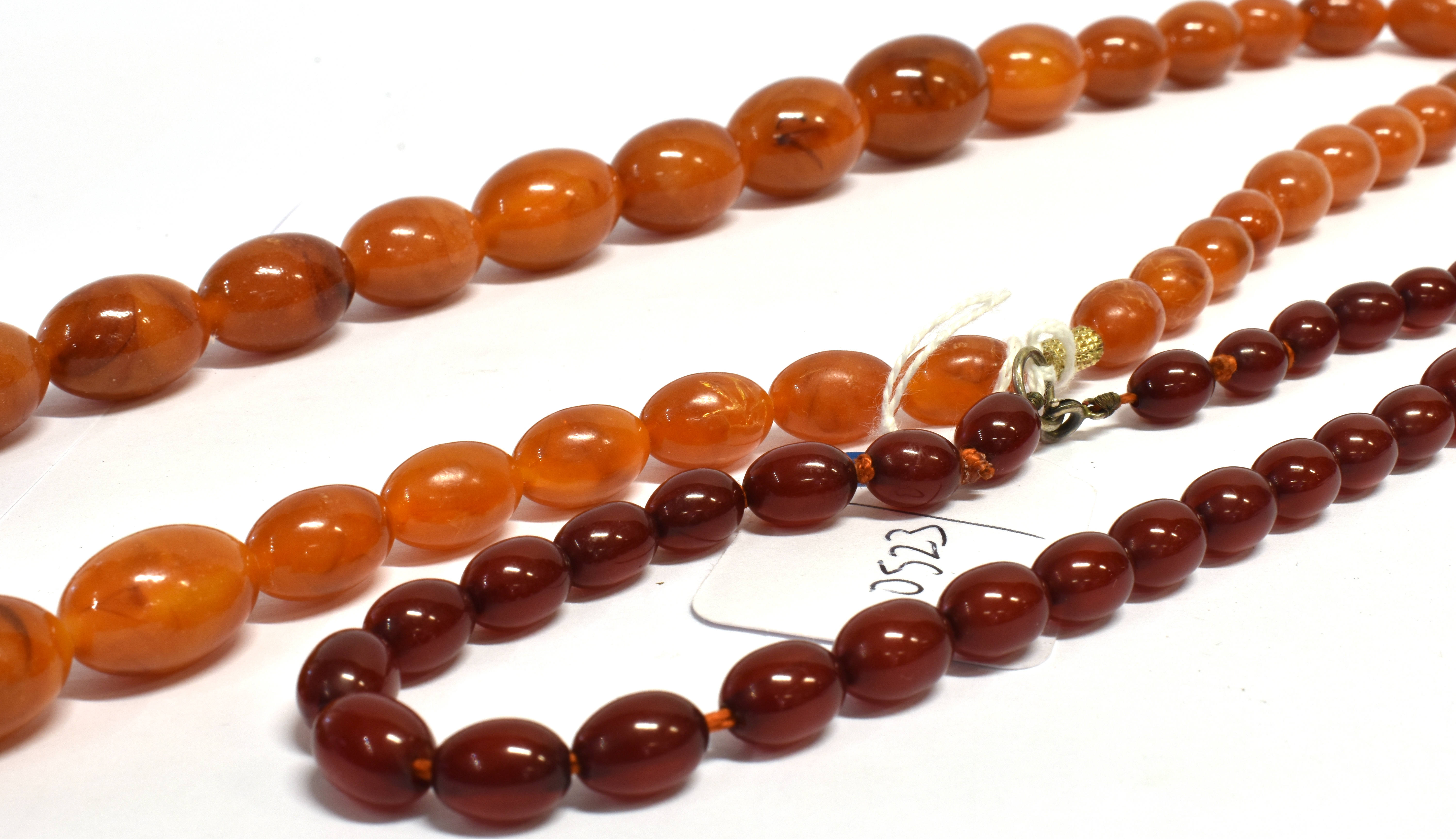 TWO AMBER TYPE BEAD NECKLACES both with graduating oval beads, one with butterscotch colour, the - Image 2 of 4