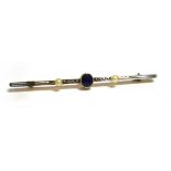 AN EDWARDIAN 15CT GOLD SAPPHIRE AND SEED PEARL BAR BROOCH small oval sapphire to centre 5mm x 4mm, a