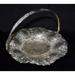 A SILVER BASKET DISH of round embossed and pierced lobed shape on pedestal base, London mark for