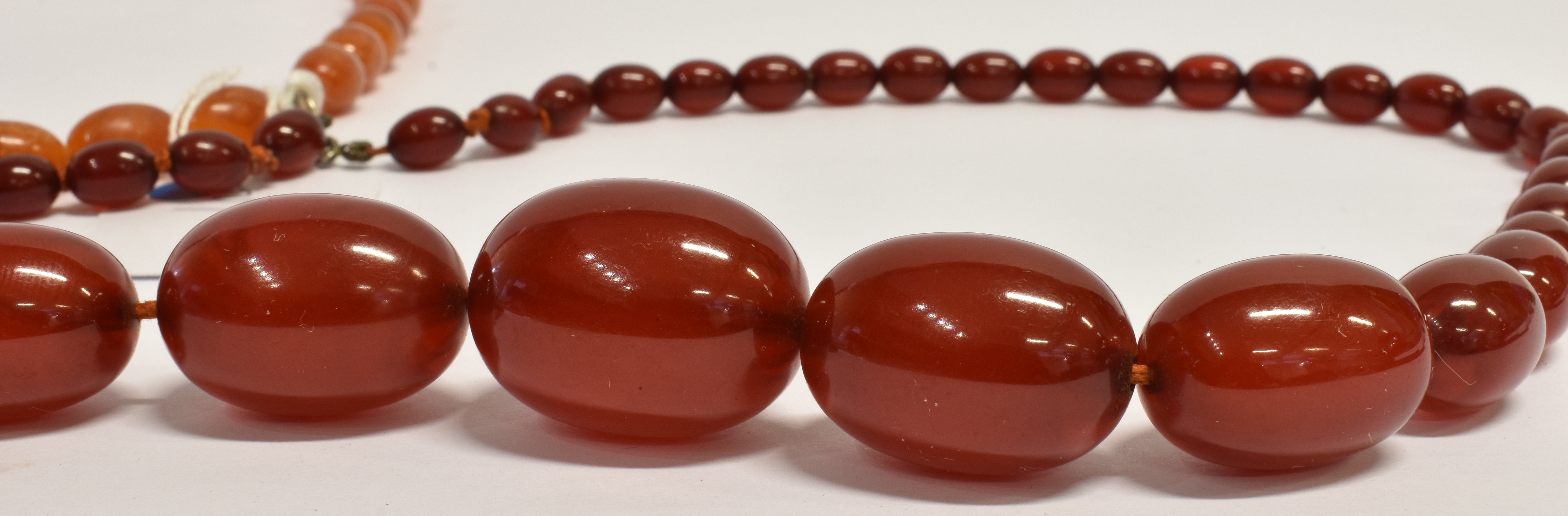 TWO AMBER TYPE BEAD NECKLACES both with graduating oval beads, one with butterscotch colour, the - Image 4 of 4