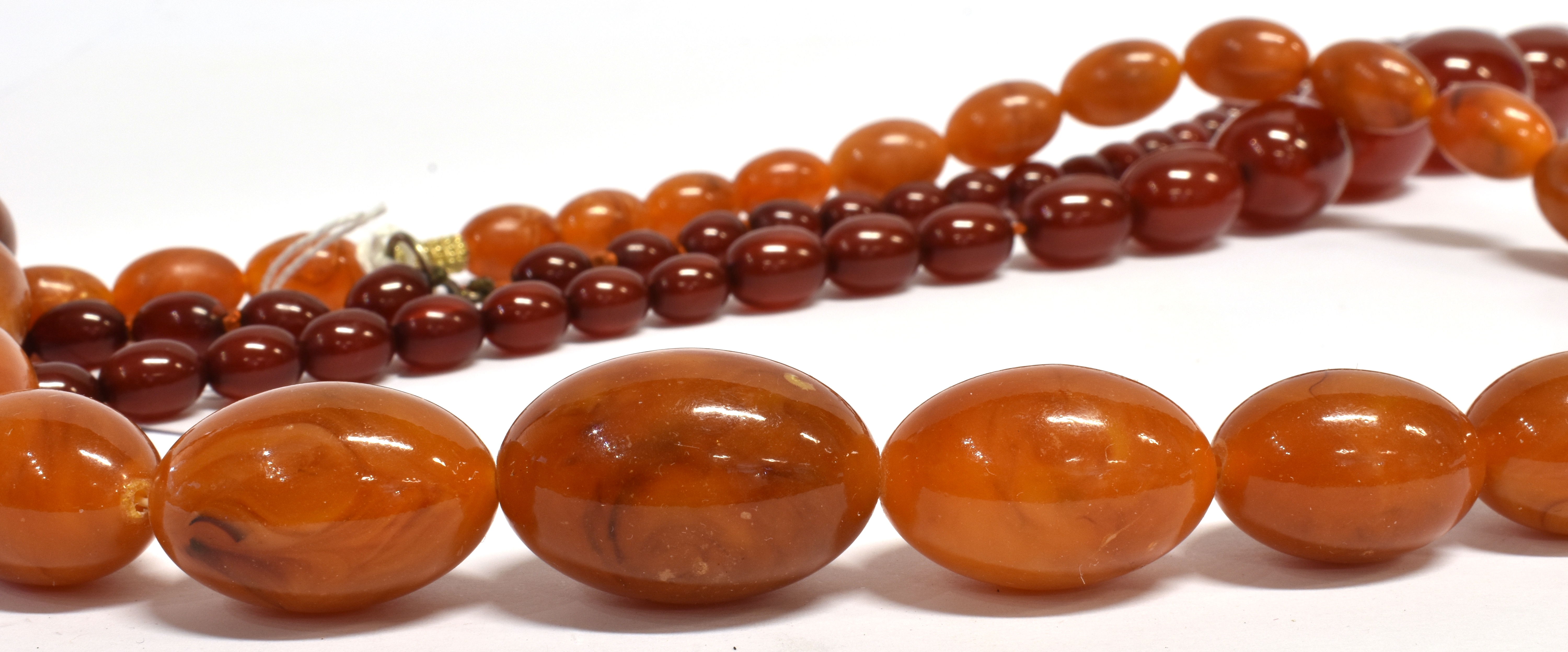 TWO AMBER TYPE BEAD NECKLACES both with graduating oval beads, one with butterscotch colour, the - Image 3 of 4