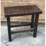 OAK STOOL, of rectangular form, the top with carved text and raised on square supports united by