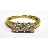 A DIAMOND THREE STONE RING the three round brilliant cut diamonds weighing a total of 0.50 carats,