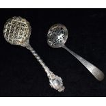 TWO SILVER SIFTING SPOONS Comprising a Georgian Scottish example with pierced scroll bowl,