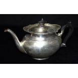 A SILVER TEAPOT The plain oval form with hardwood handle and knop, Sheffield hallmarked for 1916,